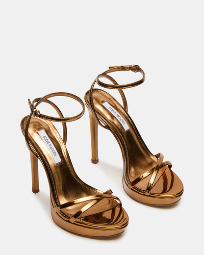 JUNI Bronze Criss Cross Stiletto Ankle Strap Women's Heel | Steve Madden Customer Favorite