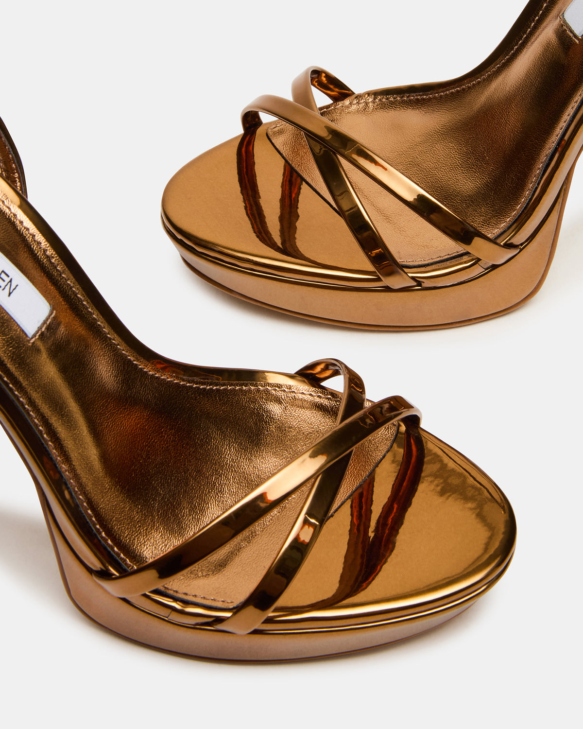 JUNI Bronze Criss Cross Stiletto Ankle Strap Women's Heel | Steve Madden Customer Favorite