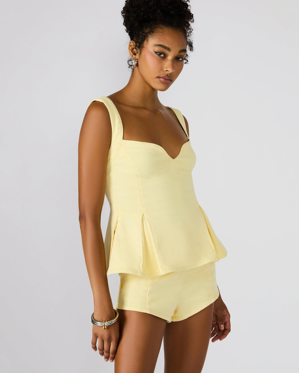 ZENIA Golden Glow Sleeveless Peplum Women's Top | Steve Madden Value